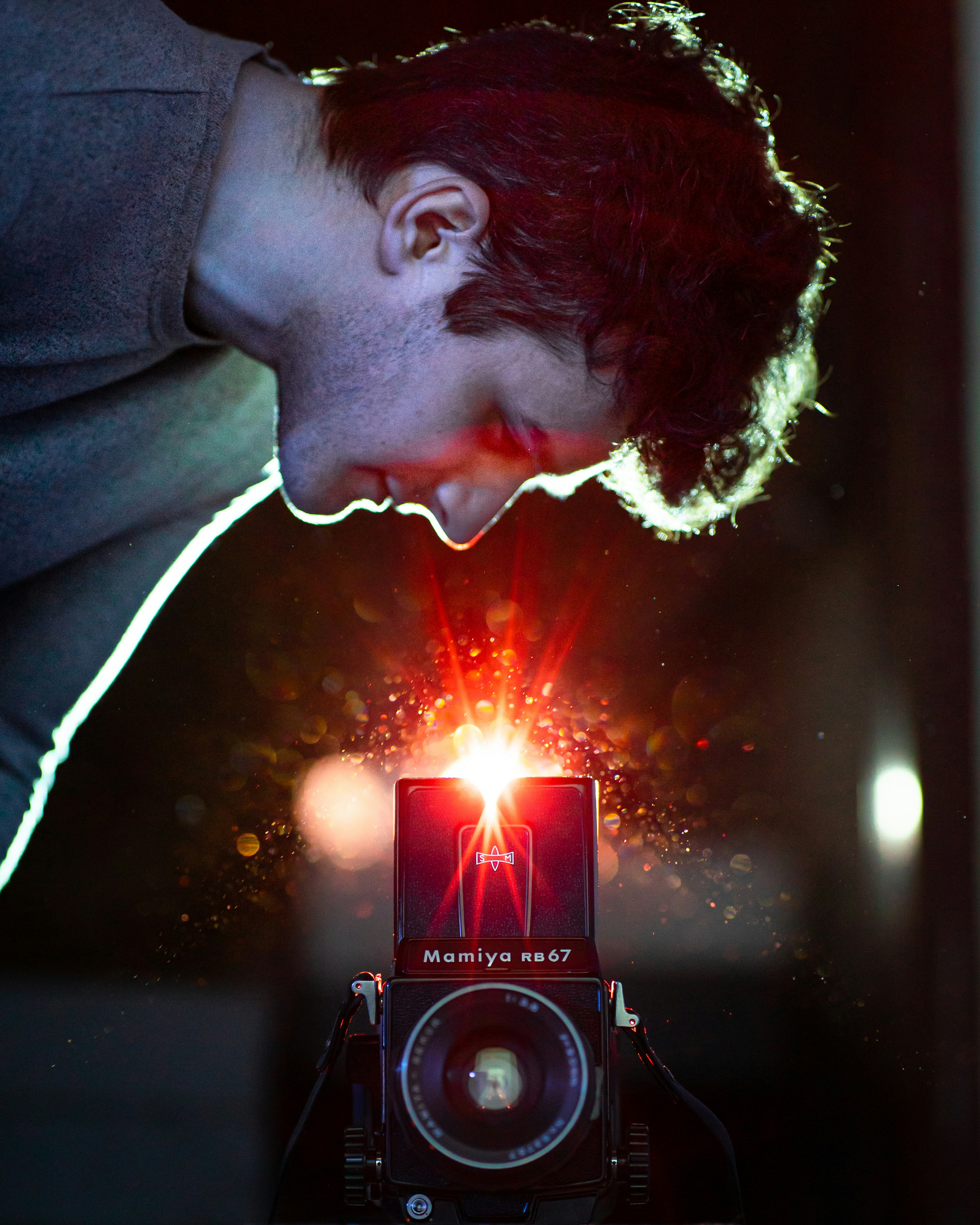 man in black hoodie holding black camera